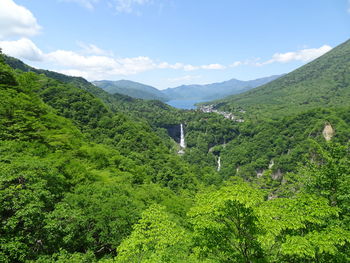 Scenic view of green mountains against sky