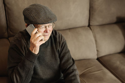 Senior man sitting on sofa