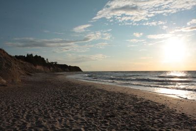 Scenic view of beach against sky during sunset