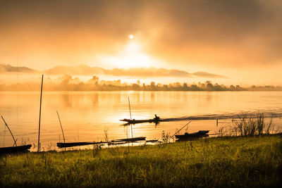 Scenic view of lake against sky during sunset