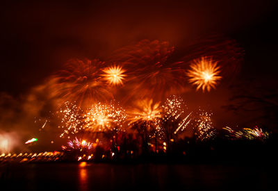 A beautiful, blurred, abstract fireworks display in riga in red tones