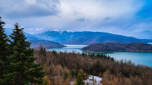 Scenic view of lake and mountains against sky