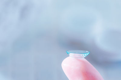 Close-up of hand holding light against blurred background