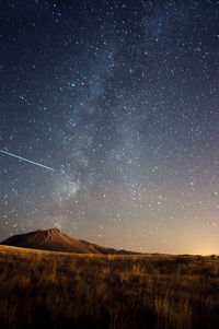 Scenic view of field against sky at night