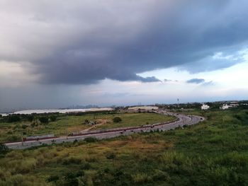 Scenic view of agricultural field against storm clouds