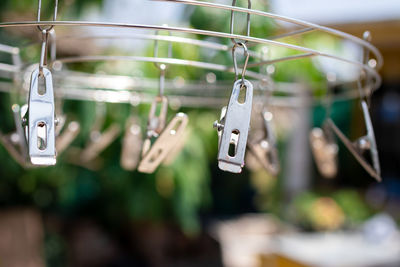 Close-up of clothespins hanging on rope