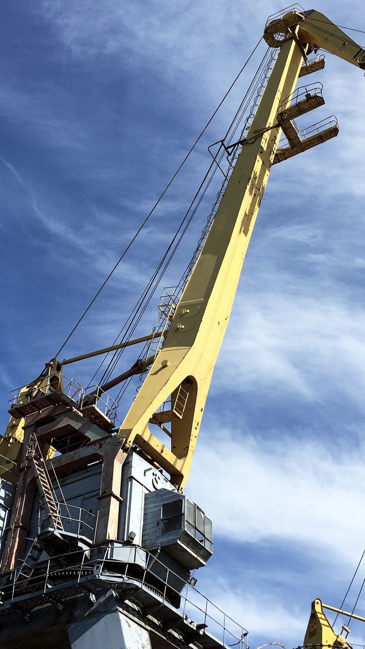 sky, cloud - sky, low angle view, machinery, industry, nature, built structure, development, architecture, crane - construction machinery, construction machinery, day, construction industry, construction site, yellow, no people, transportation, outdoors, metal, incomplete, construction vehicle, construction equipment