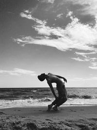 Man on beach against sky