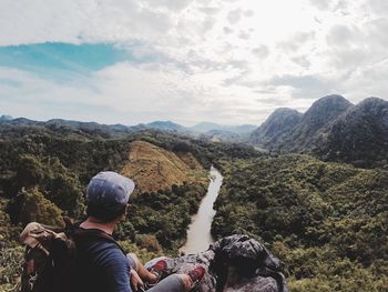 Man standing on mountain against sky