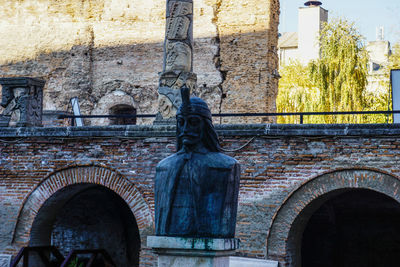 Statue in front of building