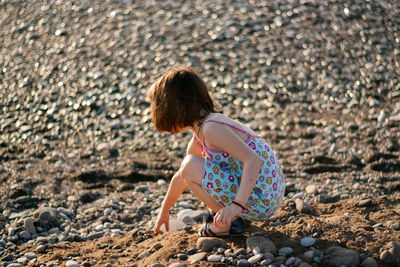 Rear view of woman on rock at beach