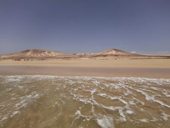 Scenic view of desert against clear sky