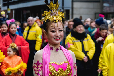 Portrait of people wearing traditional clothing standing outdoors