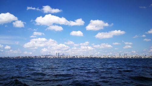 Scenic view of sea and buildings against sky