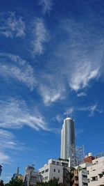 Low angle view of skyscrapers against blue sky