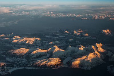 Aerial view of mountain range against sky during sunset