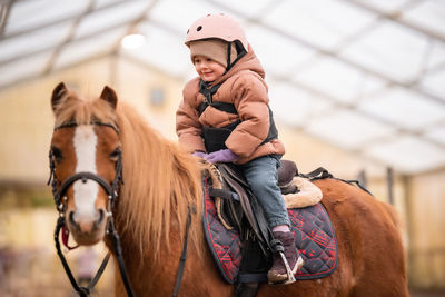 Portrait of man riding horse