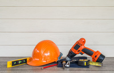 Work tools on table against wall