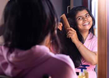 Side view of young woman using mobile phone