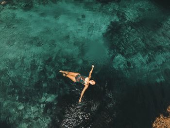 High angle view of woman swimming in sea