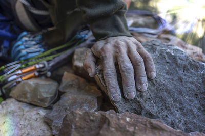 Close-up of man working on rock