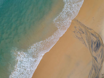 High angle view of water splashing on beach