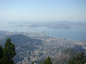 High angle view of buildings and sea against sky