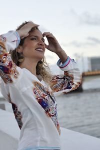 Side view of woman standing by river