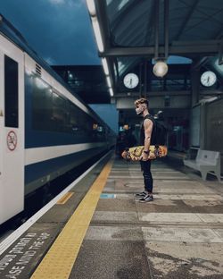 Full length of woman standing at railroad station