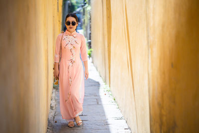 Woman standing on wall