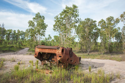 Abandoned truck on field against sky