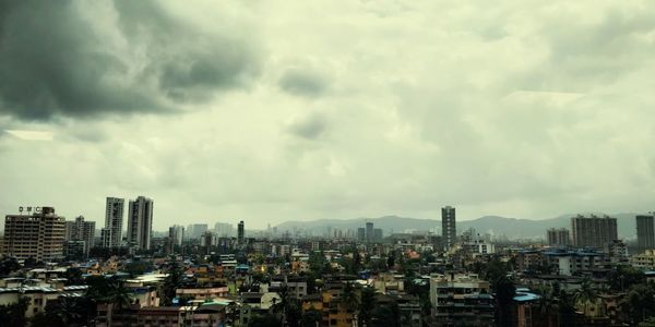 Modern buildings in city against sky