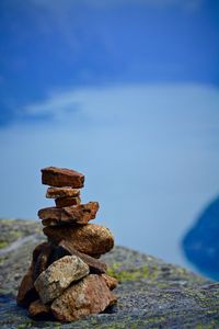 Stacked stones against lake