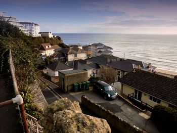 Town by sea against sky