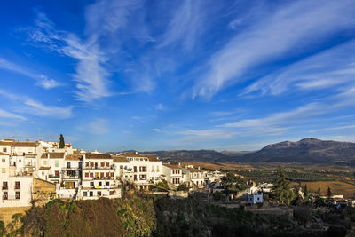 Buildings in town against sky