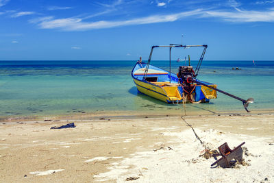 Boat on beach against sky