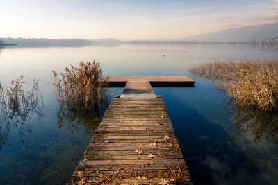 Pier over lake against sky