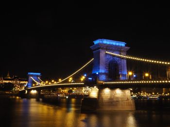 Low angle view of suspension bridge at night