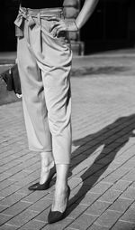 Low section of man standing on footpath