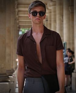 Portrait of young woman wearing sunglasses standing outdoors