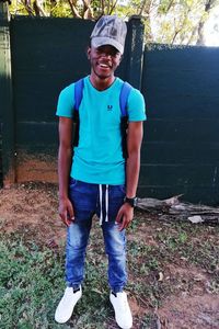 Portrait of a smiling young man standing outdoors