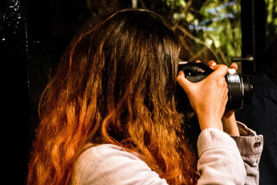 Rear view of woman photographing