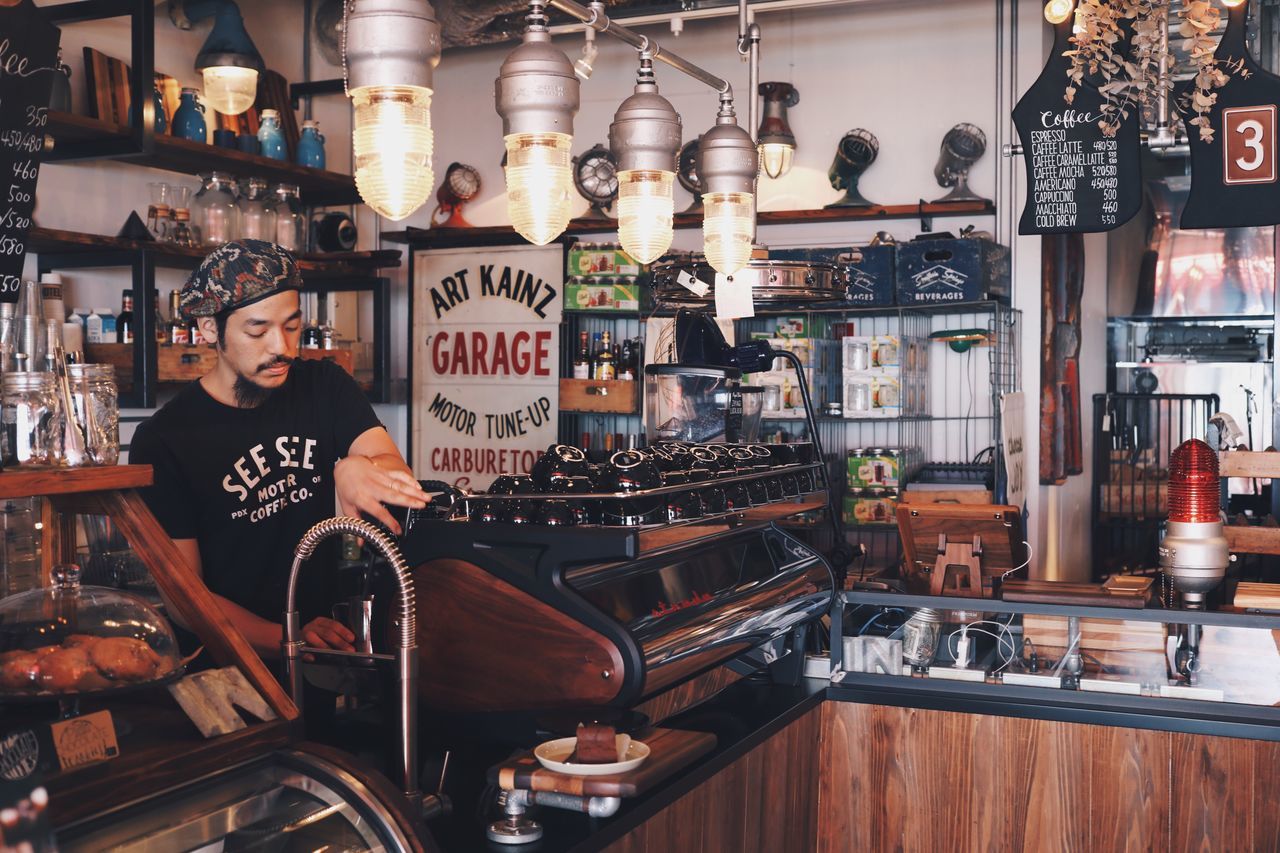 MAN SITTING IN BAR COUNTER WITH SHOP