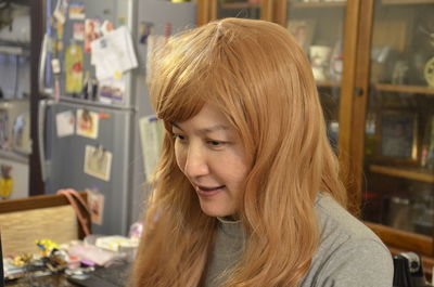 Close-up of woman with blond hair at home