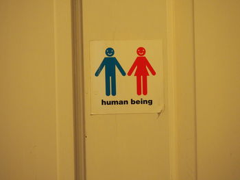 Close-up of restroom sign on door