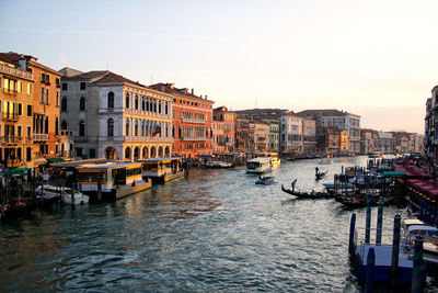 Venice form the rialto bridge at sunset. gondolas and boats in canal grande between historic palaces