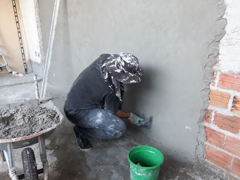 High angle view of man working on wall