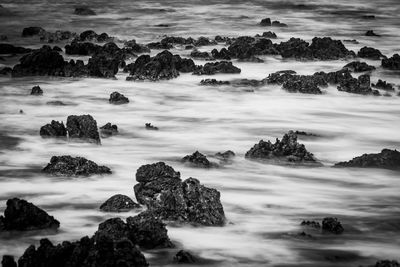 Rocks on shore against sky