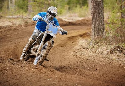 Man riding motorcycle on dirt road