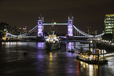 Illuminated tower bridge over river thames